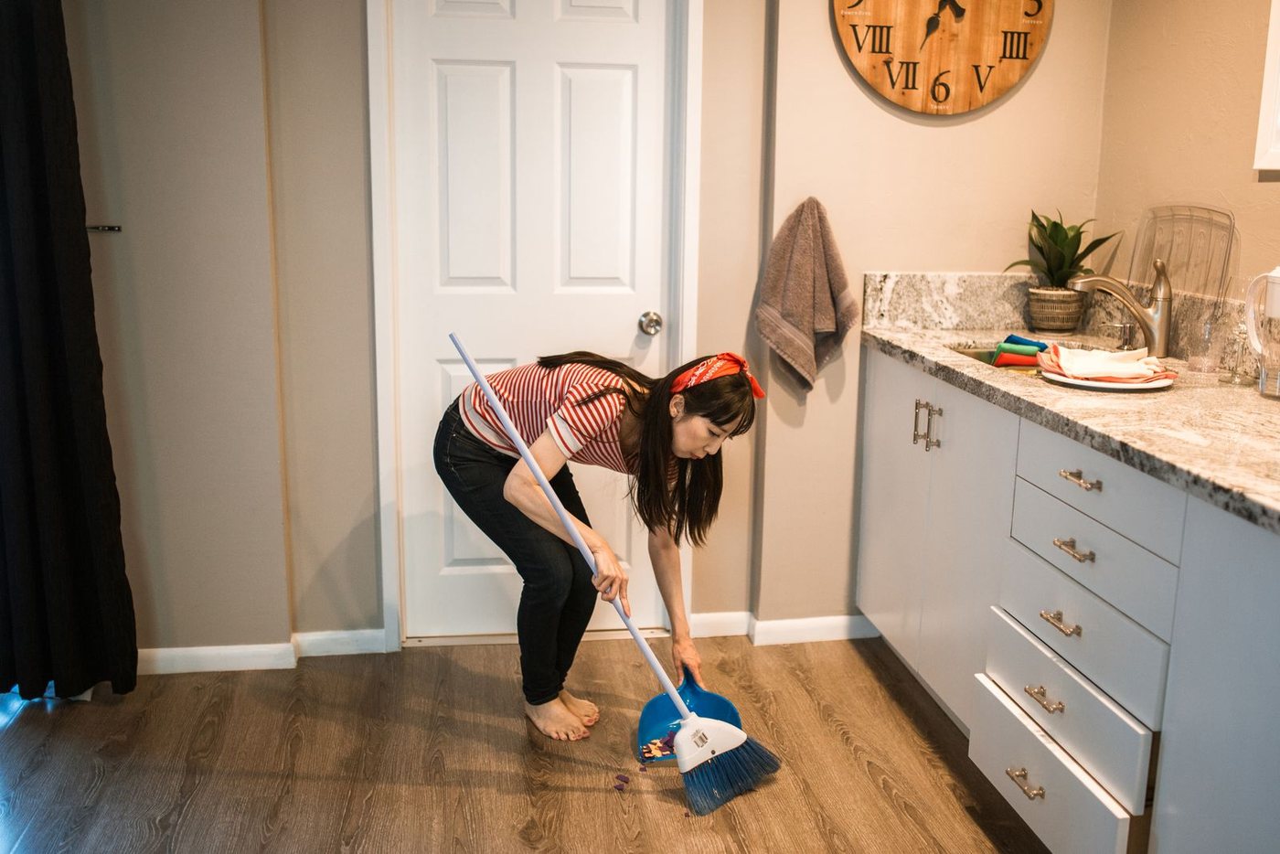 Sweeping the floor of a modern kitchen